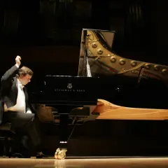 Krzysztof Jabłoński, pianista, w akcie tworzenia muzyki przy fortepianie Steinway. Data urodzenia artysty nie jest widoczna.