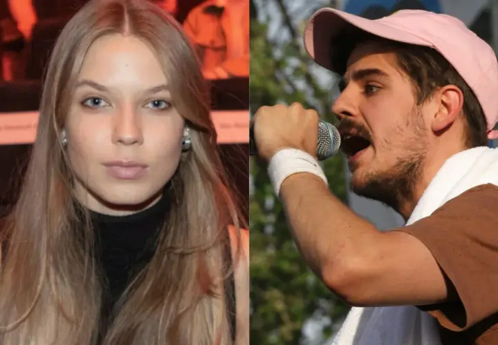 Dziewczyna z długimi blond włosami obok Taco Hemingwaya śpiewającego do mikrofonu.