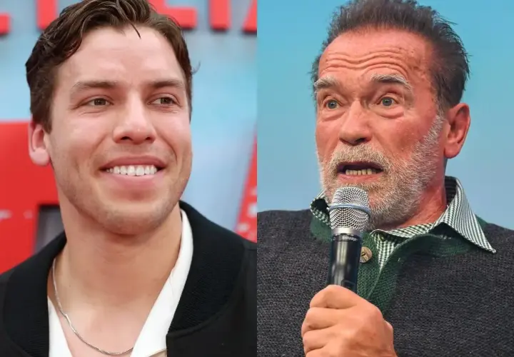 Uśmiechnięty Joseph Baena obok Arnolda Schwarzeneggera przemawiającego do mikrofonu.