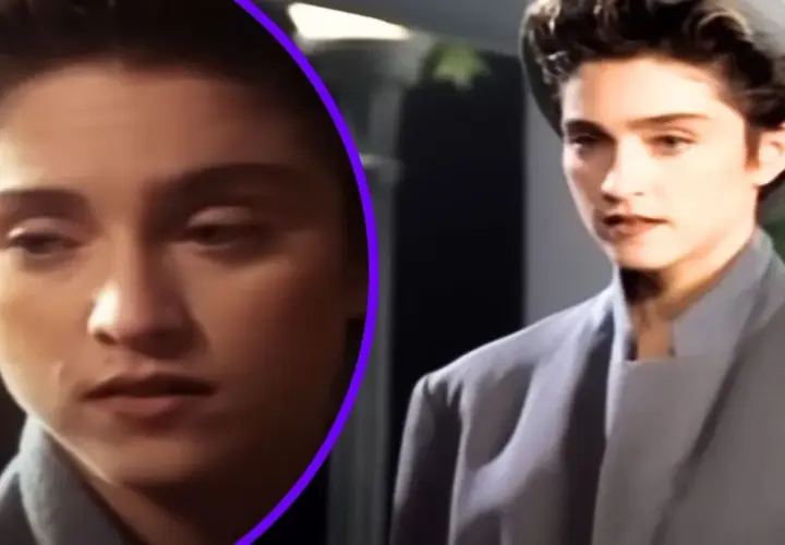 Młoda kobieta w szarym płaszczu i kapeluszu, jak z filmu "La Isla Bonita", zamyślona.